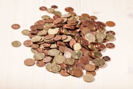 Euro coins on the light wooden tableの写真素材