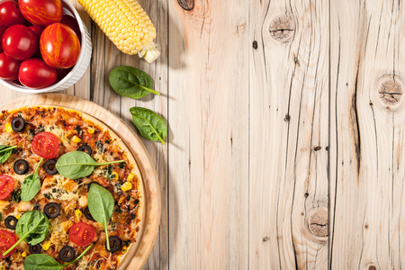 Homemade pizza on wooden backgroundの写真素材