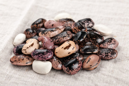 Pinto beans and white beans on linen tablecloth