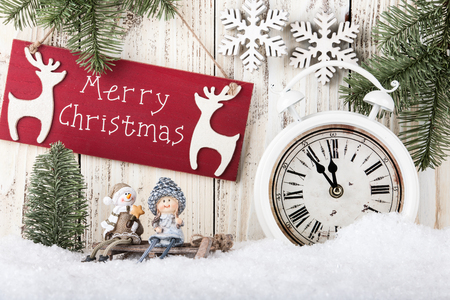 Merry Christmas card with smiling figurines on the sled, vintage alarm clockの写真素材