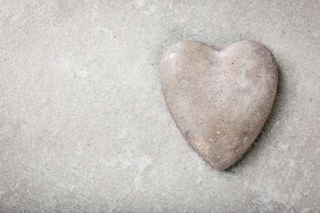 Stone heart on gray backgroundの写真素材