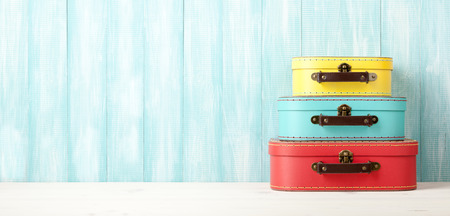 Travel concept with retro style suitcases on blue wooden backgroundの写真素材