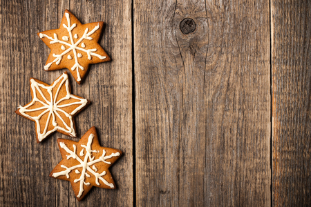 Christmas gingerbread cookies on wooden backgroundの写真素材