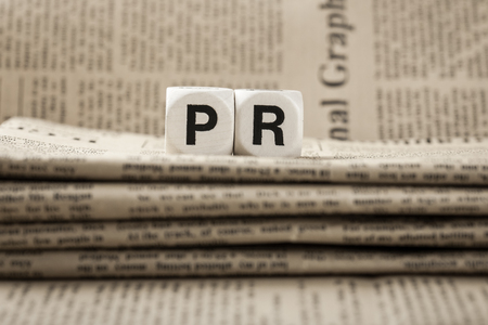 Abbreviation PR on newspapers backgroundの写真素材