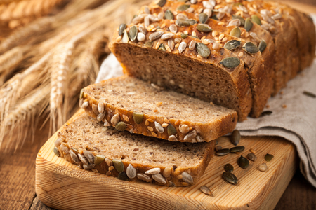 Rye grain bread on wooden cutting boardの写真素材