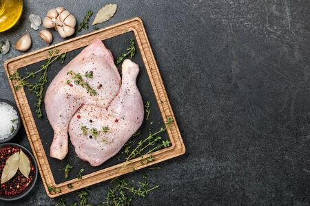 Fresh chicken legs  on cutting boardの写真素材
