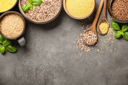 Set with various cereal grains on stone backgroundの写真素材