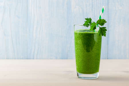 Fresh green smoothie on wooden tableの写真素材