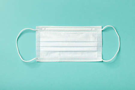 Medical face mask on blue backgroundの写真素材