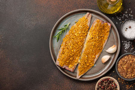 Marinated mackerel fish on ceramic plate and spices for cookingの写真素材