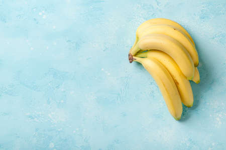 Fresh bunch of banana fruits on stone surfaceの写真素材