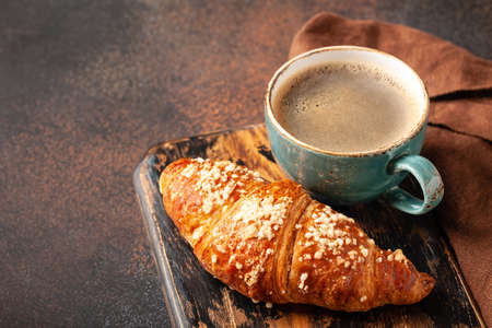 Cup of coffee and fresh croissantの写真素材