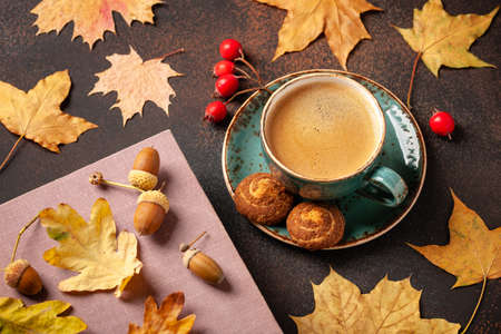 Autumn background with cup of black coffee and fall decorationの写真素材