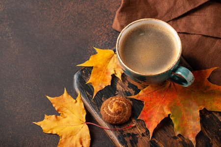 Autumn background with cup of black coffee and fall decoration
