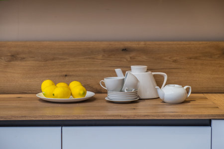 Tea set and lemons in the kitchen.