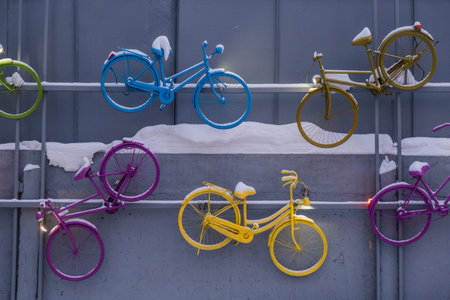 Old bicycles have become an art object in on a gray concrete wall