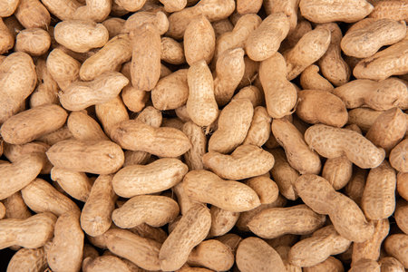 Peanuts background. Close-up of peanuts in a pile.