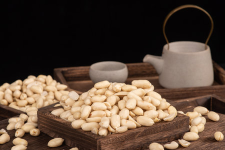 Pine nuts in a wooden box on a dark background. Selective focus.の写真素材