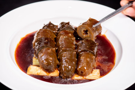 dumplings with meat in a white plate on a black background
