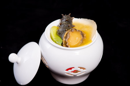 Baked egg with scallops in a white porcelain potの写真素材