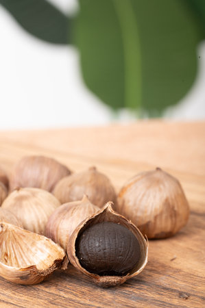 Hazelnuts on a wooden board with a green leaf in the backgroundの写真素材