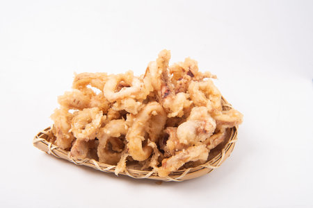 Fried squid in bamboo basket isolated on white background with clipping path