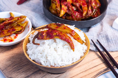 chili peppers with rice in a bowl on a wooden table.の写真素材