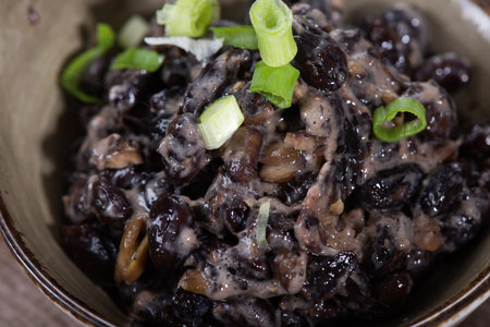 Japanese cuisine. Stir-fried black beans in soy sauce with onions