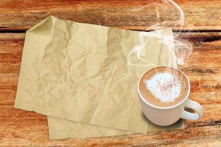 old paper sheet and hot coffee on the wood desk の写真素材