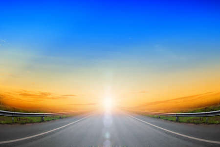 Road going up and blue skyの写真素材