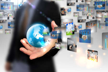 Businessman holding business world の写真素材