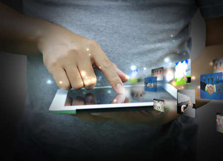 Businessman hand pressing business collection on tablet PCの写真素材