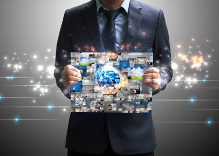 Businessman holding business world の写真素材