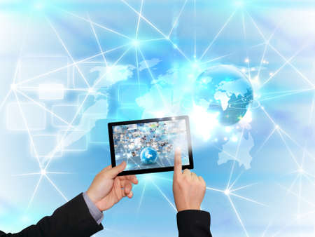 hand holding business world on tablet pc の写真素材