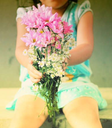 flowers bunch in little girl hands の写真素材