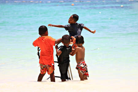Koh Lipe Satun Thailand ,March 17:During summer time in March the children on lipe Island will come out for swimming. It's the funny time for their recess.のeditorial素材