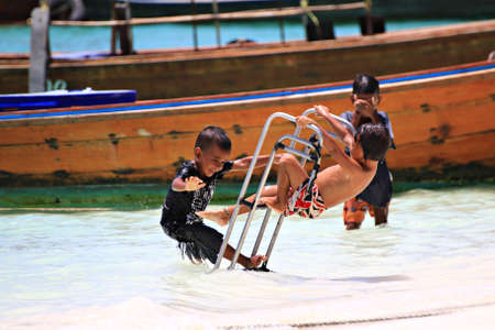 Koh Lipe Satun Thailand ,March 17:During summer time in March the children on lipe Island will come out for swimming. It's the funny time for their recess.のeditorial素材