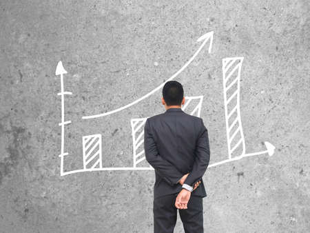 businessman standing of watching growing graph.の写真素材