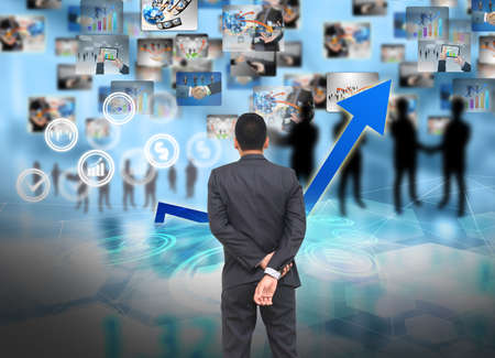 businessman standing of watching growing graph.の写真素材