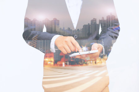 Businessman using mobile smart phone.double exposure of businessman