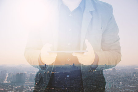 Businessman using digital tablet,double exposure of businessman.soft focus