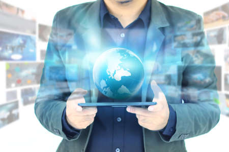 businessman holding digital world.の写真素材