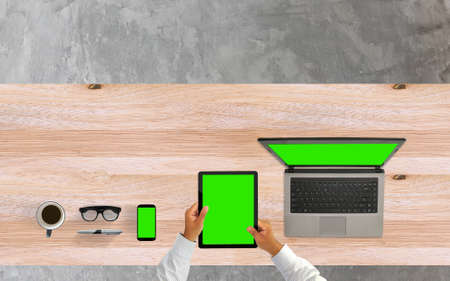 Businessman using tablet pc, laptop and smartphone mockup. desk from above.の写真素材