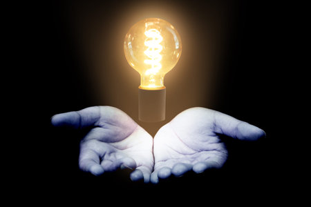 Hand Holding Light Bulb