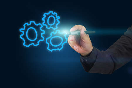 Businessman drawing gear symbol.の写真素材