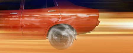 close up red car wheel spin.の写真素材