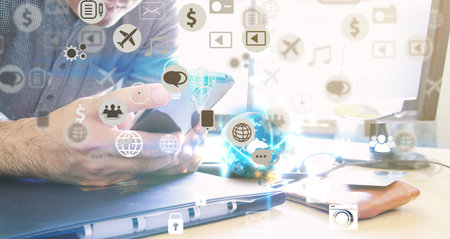 Businessman using mobile smart phone.hand touching screen social icons.の写真素材