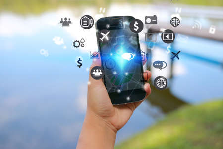 Hand holding smart phone. Social media concept,iconsの写真素材