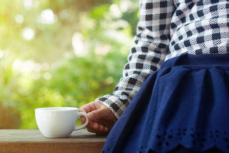 little girl holding tea cup.                                      の写真素材