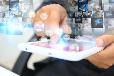 Businessman touch screen tablet. Application icons interface on screen. Business concept, New media technologyの写真素材